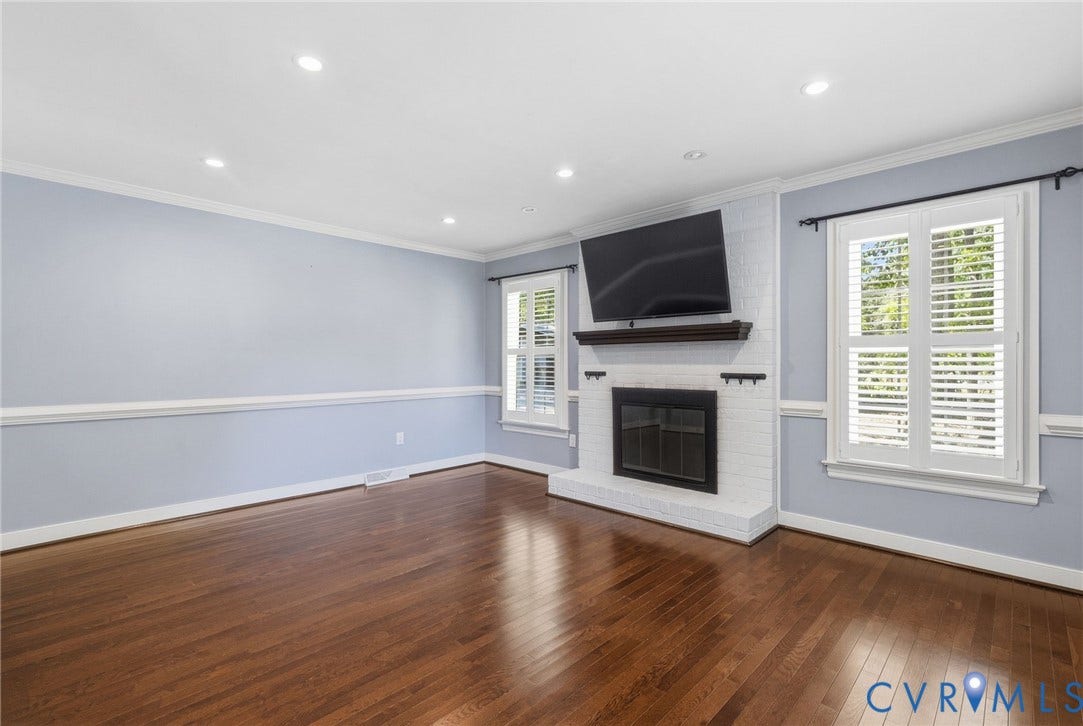 2137 Scarlet Mill Lane, Powhatan, VA 23139 Living area featuring wood-finish flooring, recessed lighting, crown molding, chair rail trim, and a white brick fireplace with a wood mantel