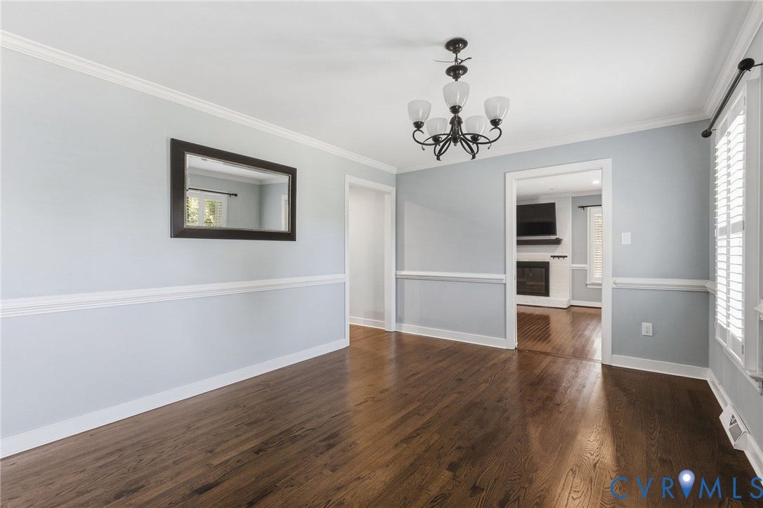2137 Scarlet Mill Lane, Powhatan, VA 23139 Room featuring wood-finish flooring, crown molding, chair rail trim, and an iron chandelier