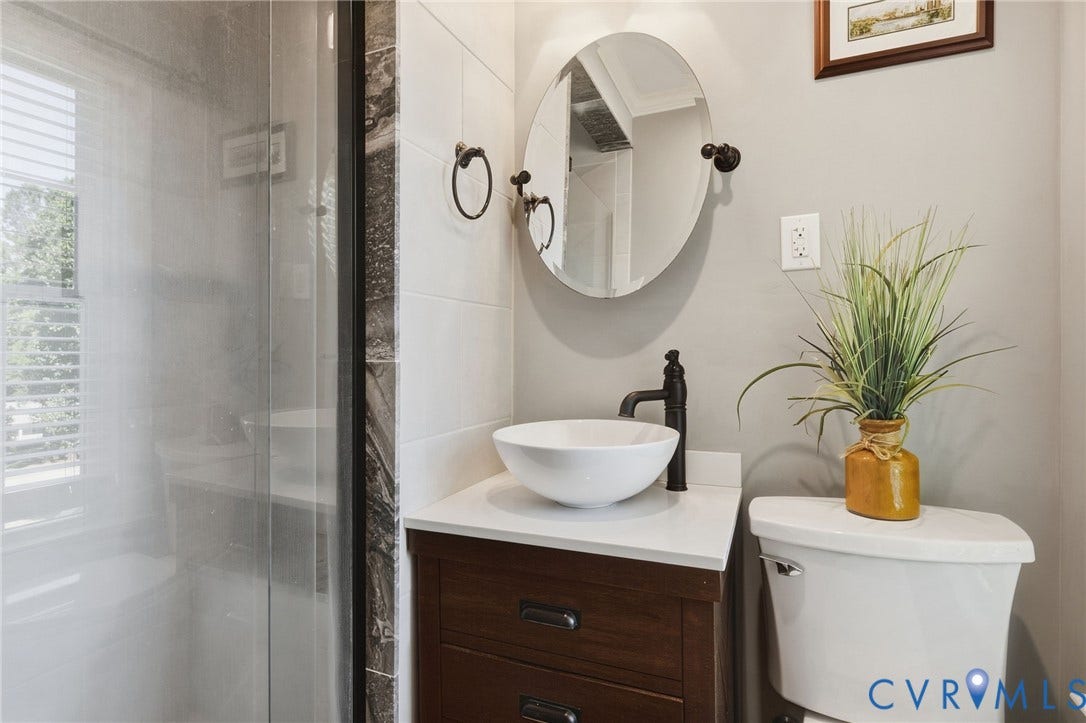 2137 Scarlet Mill Lane, Powhatan, VA 23139 Bathroom vanity with a white composite countertop, a circular vessel sink, and a high-arc matte black faucet
