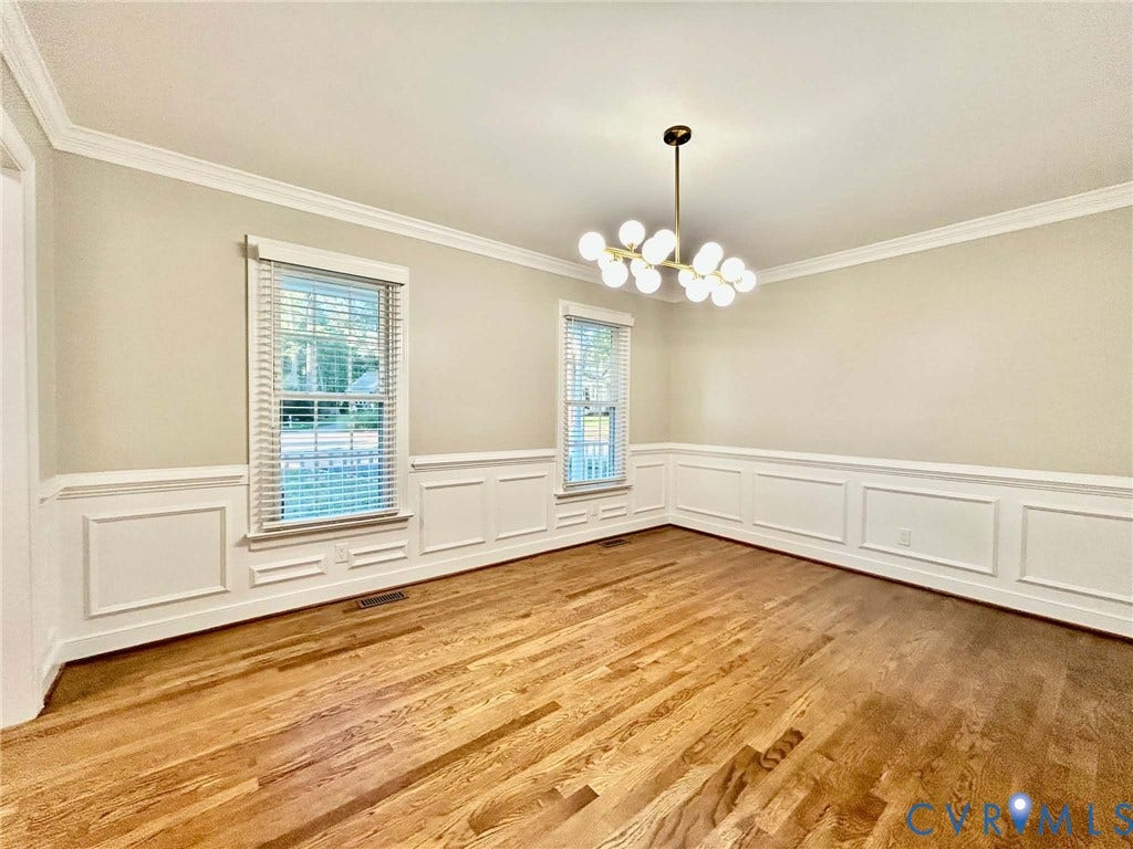 2255 Oak Bay Lane, Henrico, VA 23233 Dining space featuring wood-finish flooring, white wainscoting, crown molding, multi-light chandelier, and large windows with blinds