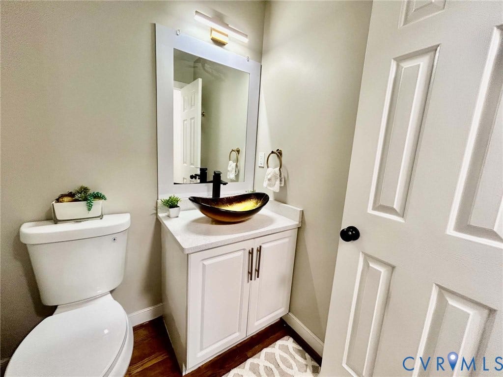 2255 Oak Bay Lane, Henrico, VA 23233 Vanity featuring a stone-composite countertop, vessel sink, matte black faucet, and white shaker-style cabinetry with metal pulls