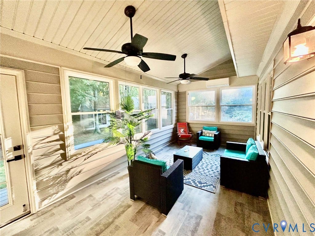2255 Oak Bay Lane, Henrico, VA 23233 Enclosed porch featuring wood-finish flooring, vaulted ceilings with dual ceiling fans, horizontal siding, and multiple large windows