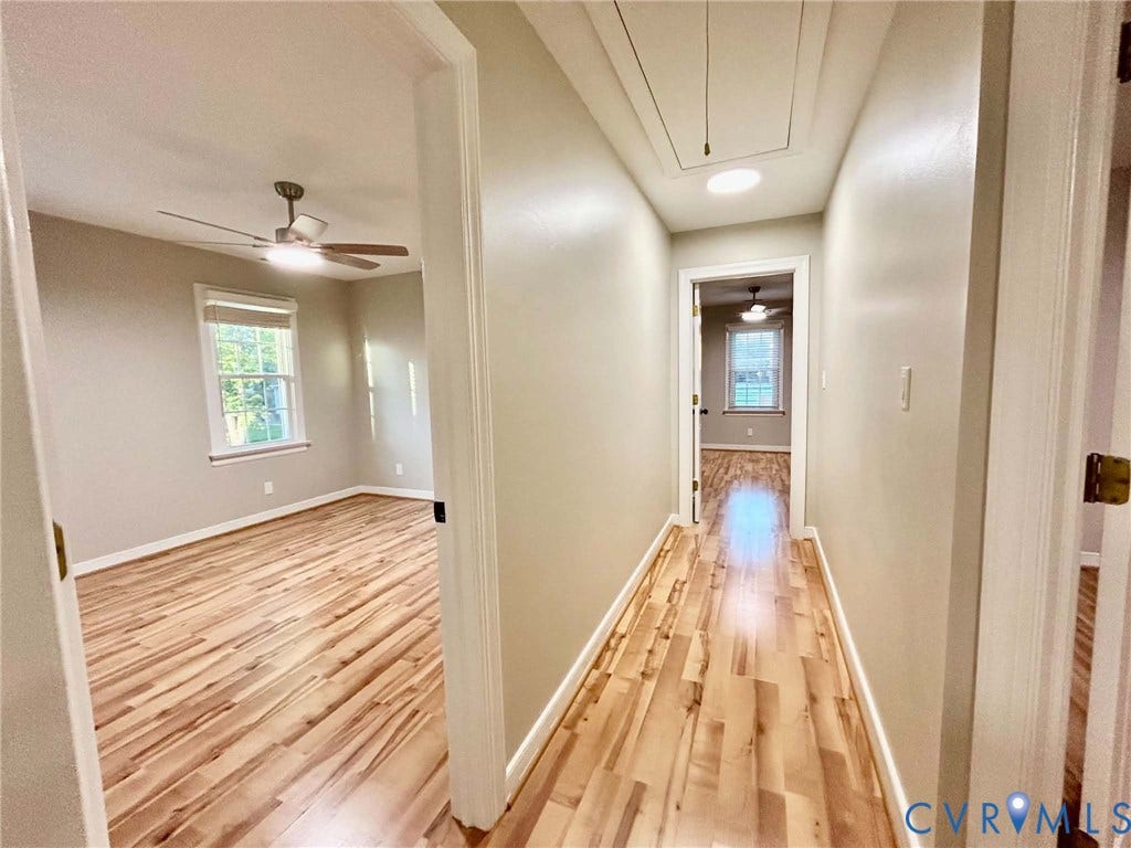 2255 Oak Bay Lane, Henrico, VA 23233 Hallway featuring wood-finish flooring, recessed ceiling lighting, and attic access, with entry points to rooms containing wood-finish flooring, multi-pane windows, and ceiling fans