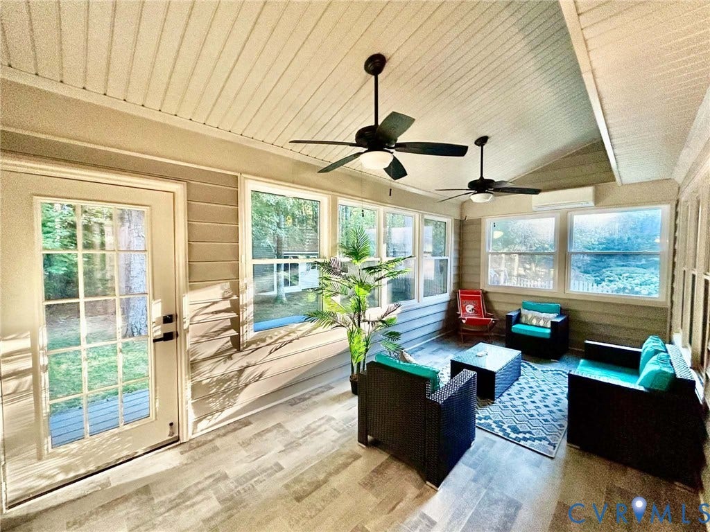 2255 Oak Bay Lane, Henrico, VA 23233 Enclosed porch featuring wood-finish flooring, beadboard ceiling, dual ceiling fans, wall-mounted climate control unit, and multiple windows with muntin detailing