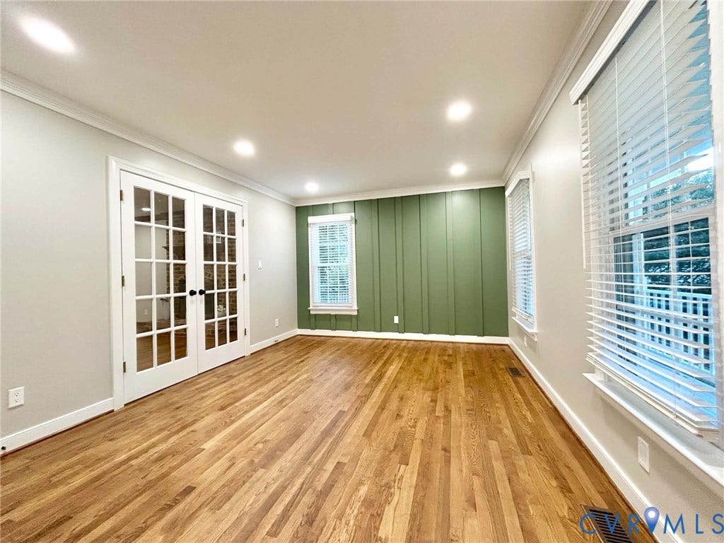 2255 Oak Bay Lane, Henrico, VA 23233 Wood-finish flooring, vertical board-and-batten accent wall, recessed lighting, and white-trimmed glass-paneled double doors