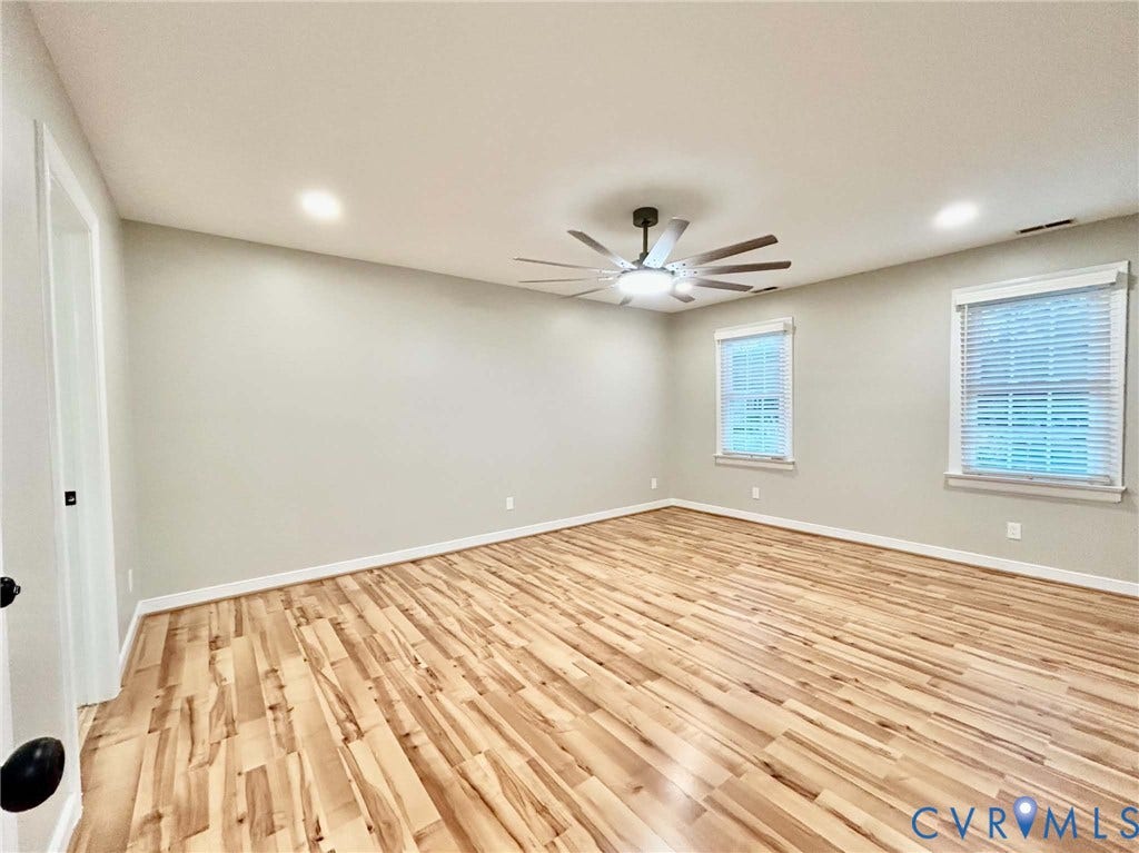 2255 Oak Bay Lane, Henrico, VA 23233 Neutral-toned interior featuring wood-finish flooring, recessed lighting, a multi-blade ceiling fan with integrated light fixture, and dual windows with window blinds