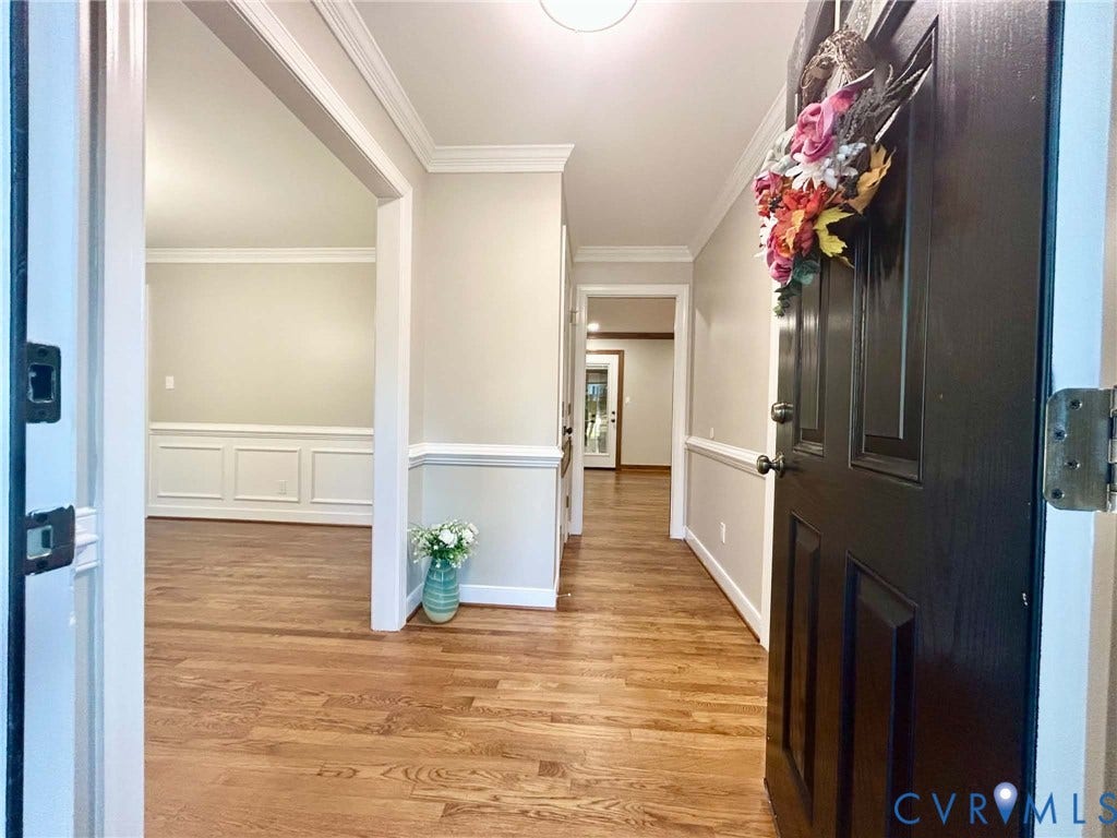 2255 Oak Bay Lane, Henrico, VA 23233 Entryway featuring wood-finish flooring, crisp crown molding, and wainscoting