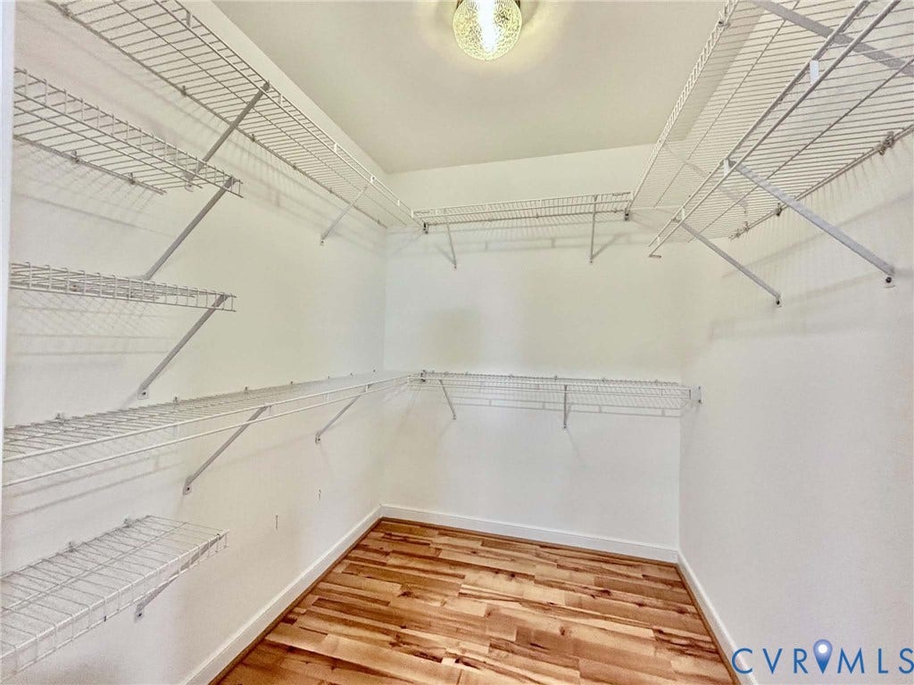 2255 Oak Bay Lane, Henrico, VA 23233 Walk-in storage space featuring wood-finish flooring, white walls, and multi-tier wire shelving with an overhead flush-mount light fixture