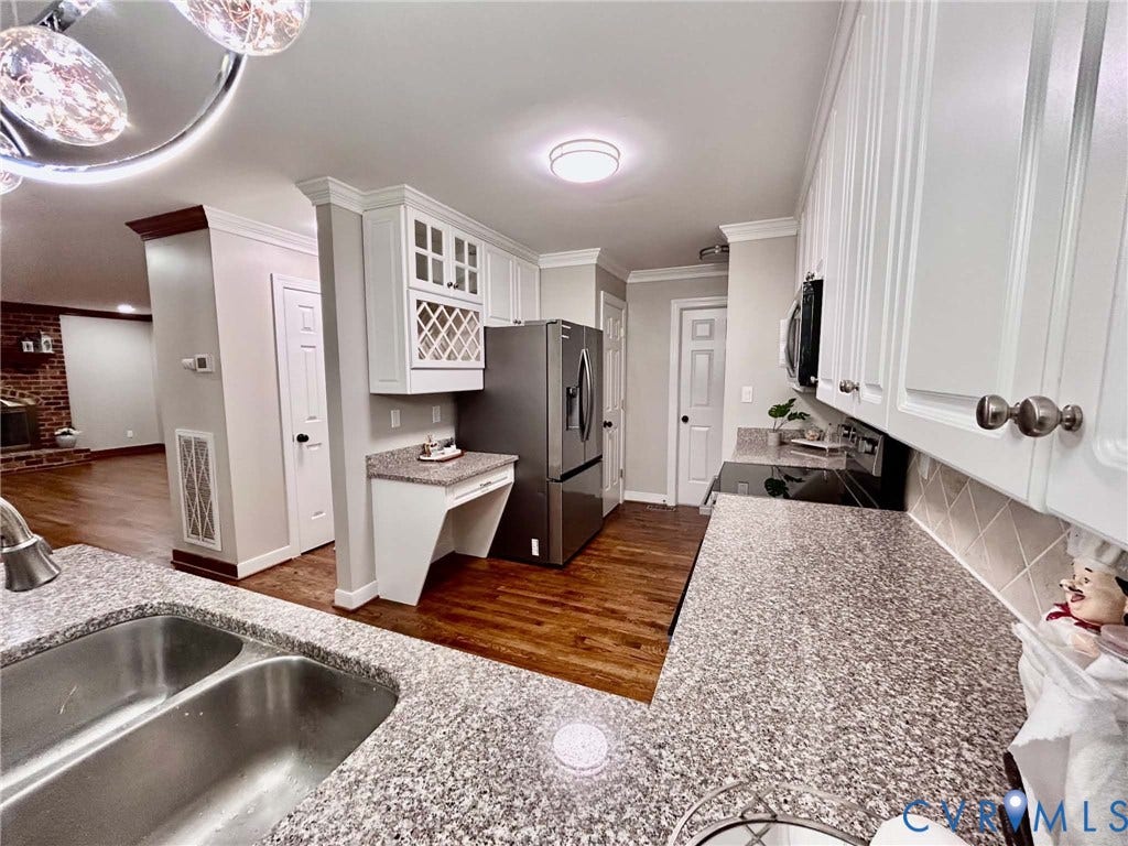 2255 Oak Bay Lane, Henrico, VA 23233 Kitchen featuring white cabinetry, stone-finish countertops, wood-finish flooring, built-in wine storage, and a dual-basin stainless steel sink