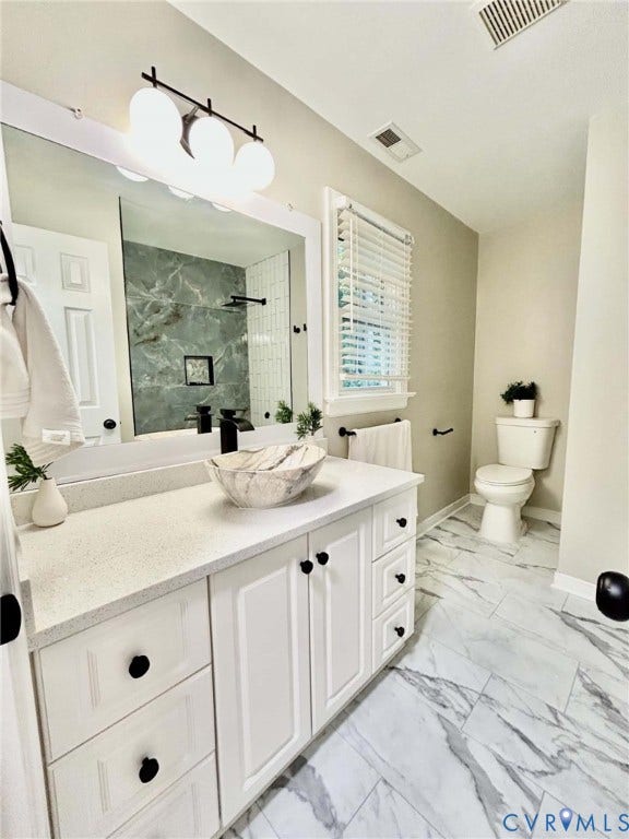 2255 Oak Bay Lane, Henrico, VA 23233 White vanity cabinet with a stone countertop, vessel sink, matte black faucet, and large-format tile flooring