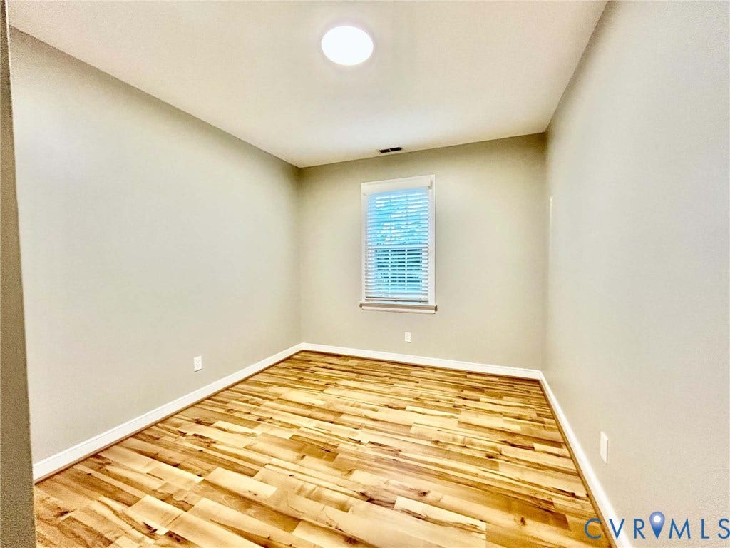 2255 Oak Bay Lane, Henrico, VA 23233 Room featuring wood-finish flooring, neutral wall paint, and a single window with installed blinds
