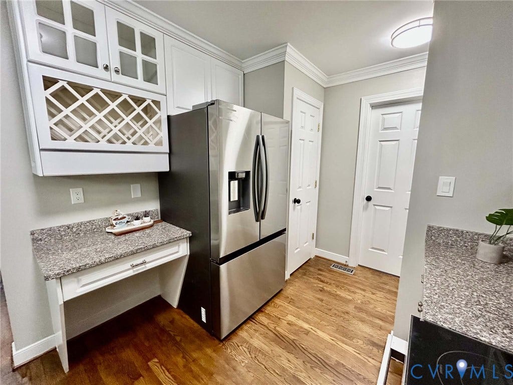 2255 Oak Bay Lane, Henrico, VA 23233 White cabinetry with glass-fronted upper doors, integrated wine rack, stone-finish countertops, stainless steel refrigerator, and wood-finish flooring
