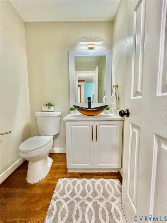 2255 Oak Bay Lane, Henrico, VA 23233 White vanity with a glass vessel sink, stone countertop, matte black faucet, and wood-finish flooring