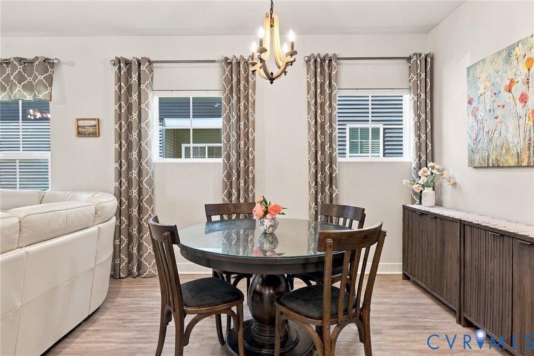 1716 German School Road, Westlake Heights, Richmond, VA 23225 Wood-finish flooring, dual windows with grid inserts, and a tiered chandelier with wood-tone accents