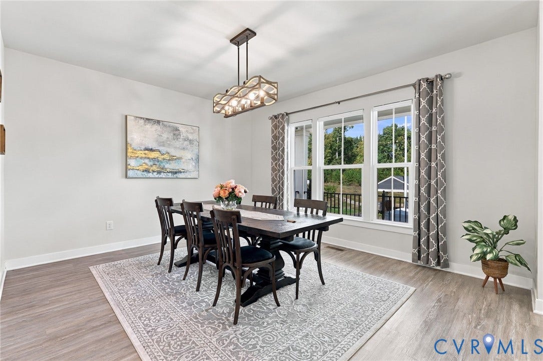 1716 German School Road, Westlake Heights, Richmond, VA 23225 Dining area featuring wood-finish flooring, a geometric multi-light pendant fixture, and a bank of three double-hung windows