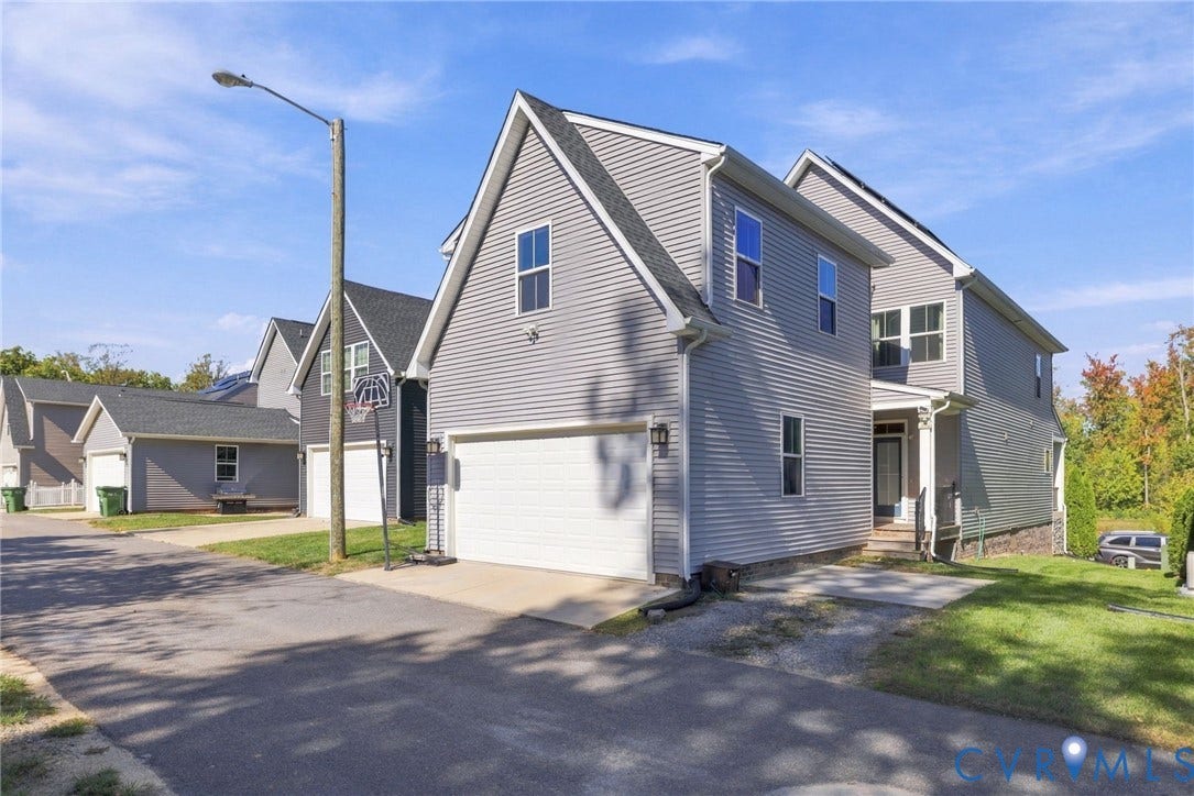 1716 German School Road, Westlake Heights, Richmond, VA 23225 Two-story residence featuring grey vinyl siding, an attached two-car garage, and an asphalt-shingle roofline