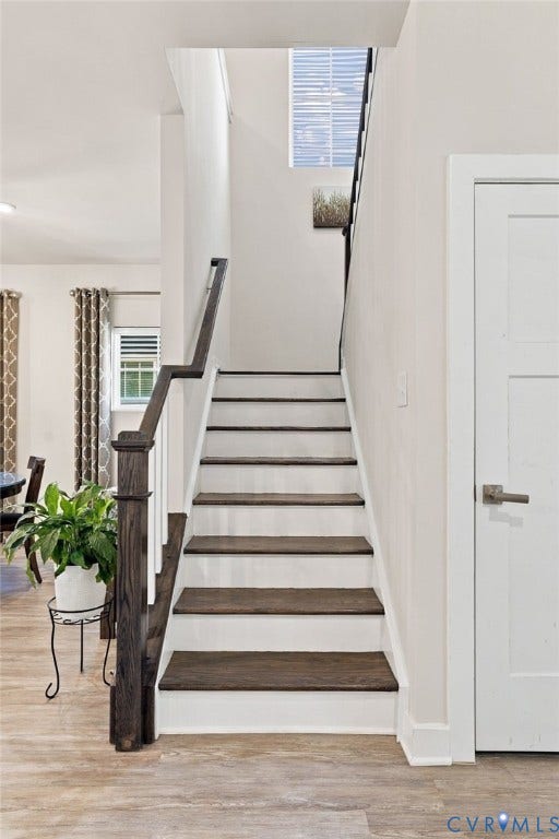 1716 German School Road, Westlake Heights, Richmond, VA 23225 Staircase featuring dark-stained wood treads, white risers, a wood-finish handrail, and square balusters