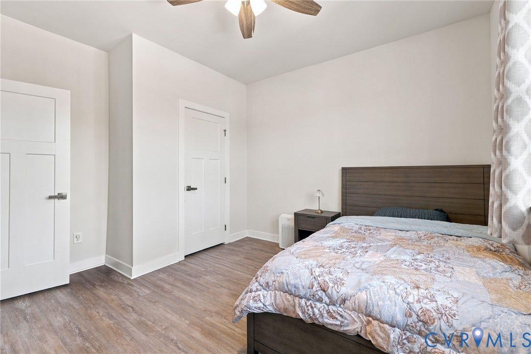 1716 German School Road, Westlake Heights, Richmond, VA 23225 Neutral-toned interior featuring wood-finish flooring, two shaker-style panel doors, and a ceiling fan with integrated lighting