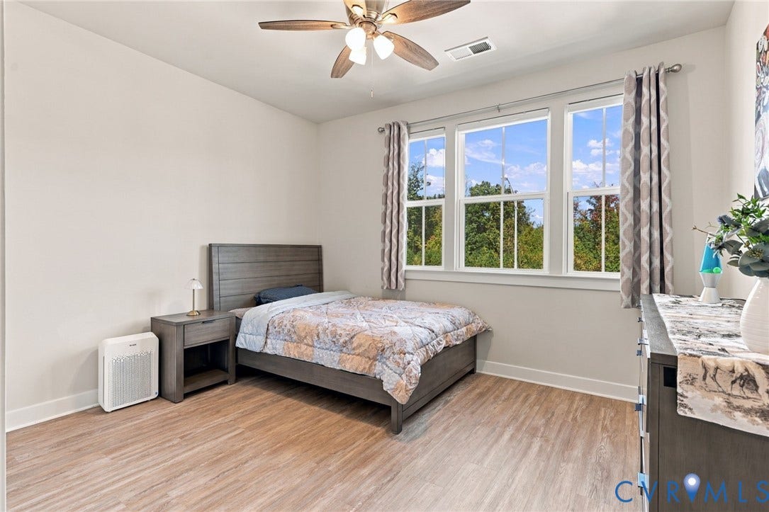 1716 German School Road, Westlake Heights, Richmond, VA 23225 Wood-finish flooring, triple-pane window configuration, and a multi-blade ceiling fan with integrated lighting