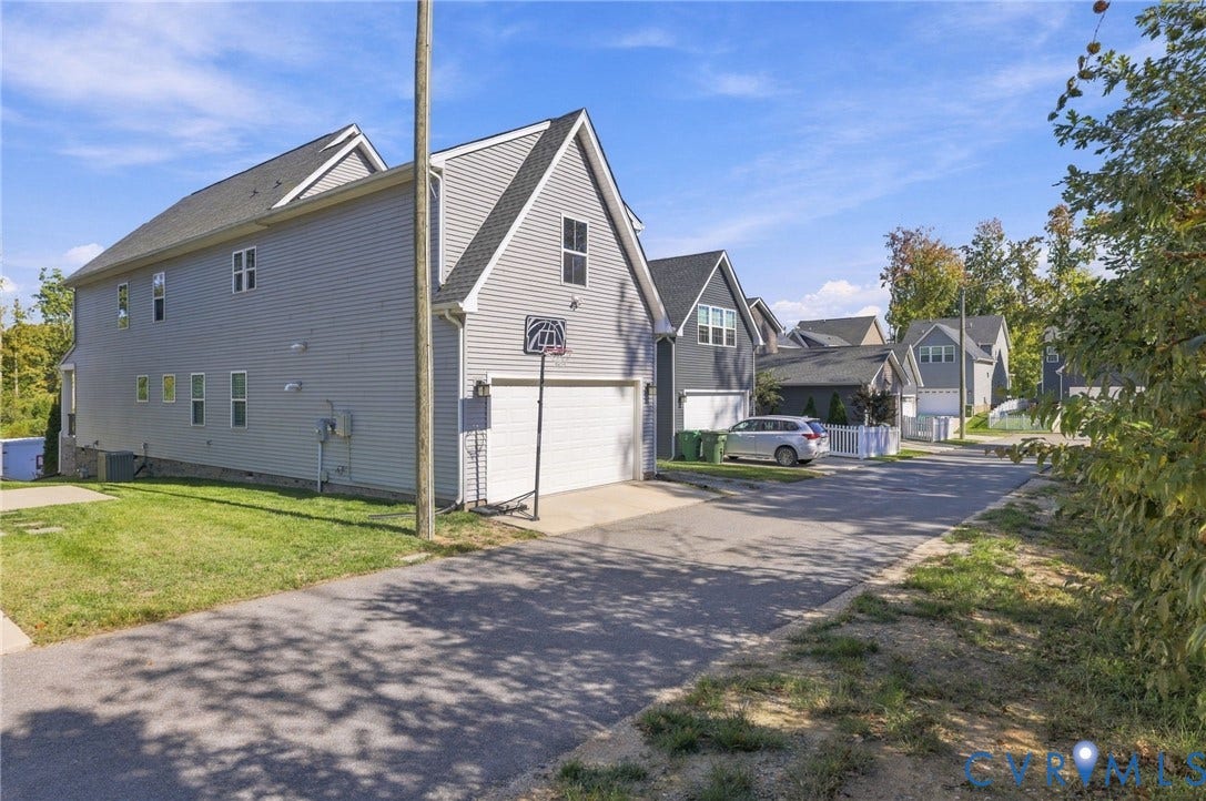 1716 German School Road, Westlake Heights, Richmond, VA 23225 Two-story residence featuring light gray horizontal siding, a steeply pitched roofline, an attached two-car garage, and asphalt driveway