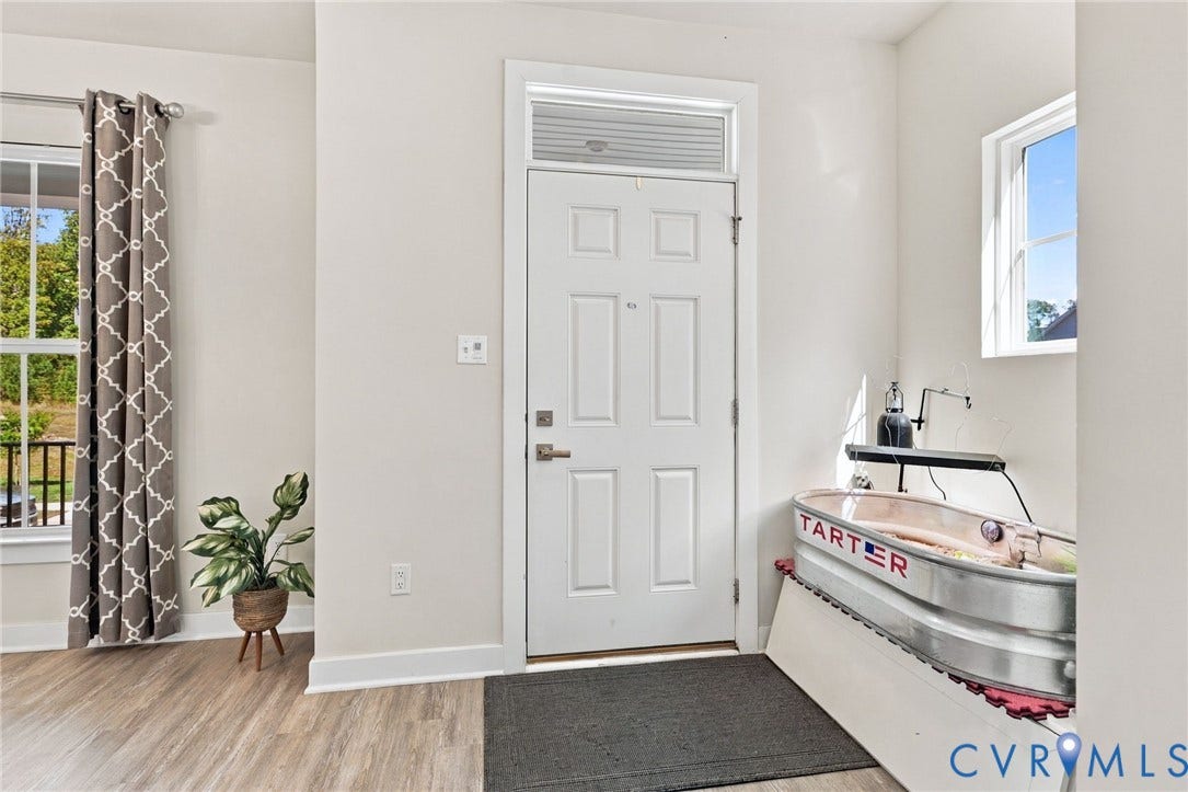1716 German School Road, Westlake Heights, Richmond, VA 23225 Entryway featuring a white six-panel door with transom window, wood-finish flooring, and multiple windows providing natural light