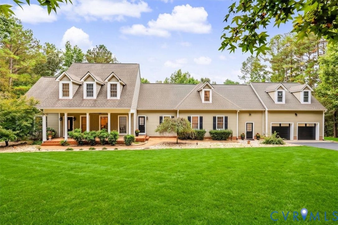 6650 Vintage Rose Lane, New Kent, VA 23140 Traditional exterior featuring light-toned horizontal siding, a covered front porch, decorative dormer windows, and an attached two-car garage