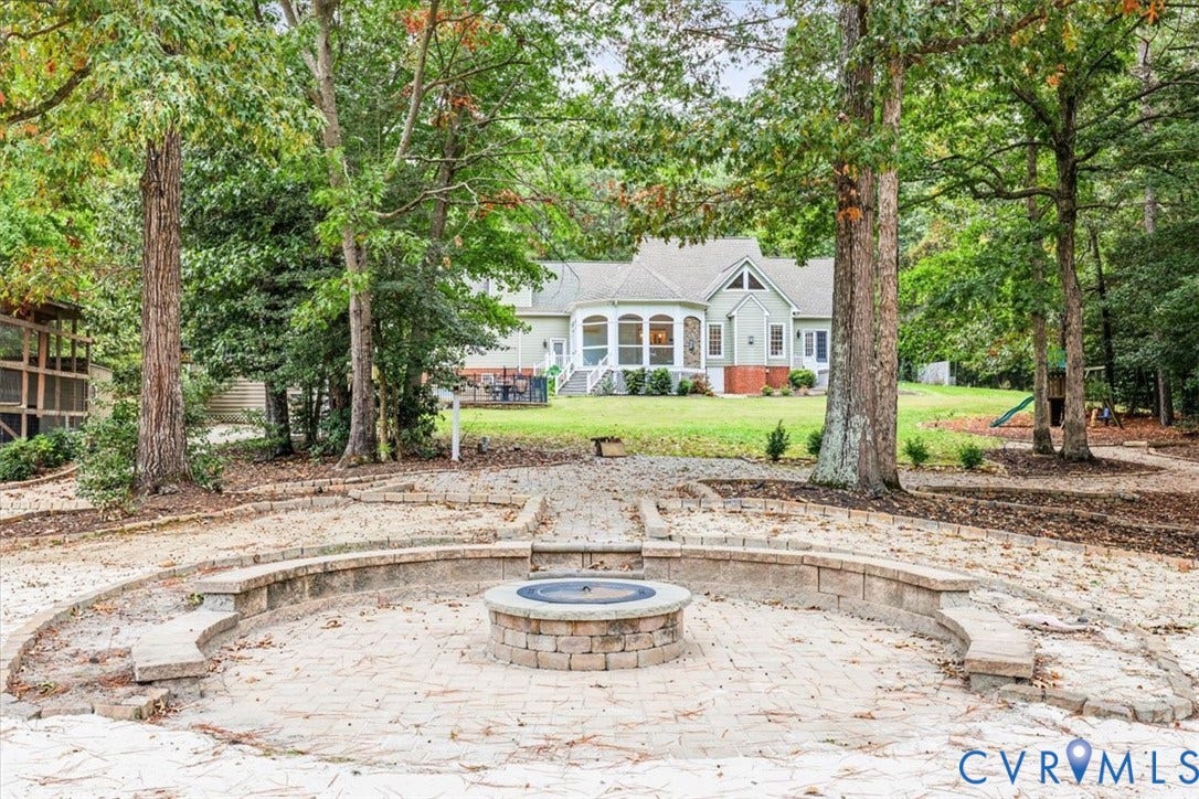 6650 Vintage Rose Lane, New Kent, VA 23140 Overlooking the pond, beautiful hardscaping seating area around firepit.