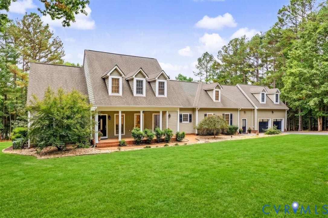 6650 Vintage Rose Lane, New Kent, VA 23140 Traditional residence featuring a covered front porch, brick-paver entry, dormer windows, multi-pitched roofline, and an attached two-car garage