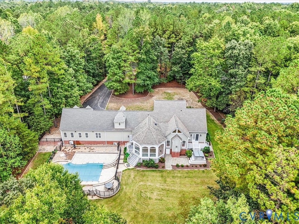6650 Vintage Rose Lane, New Kent, VA 23140 Nice view of the home with the pool, landscaping, hardscaping and patio with hot tub.