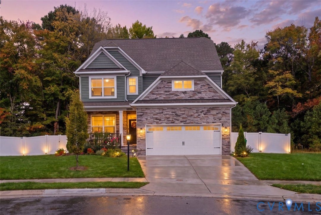2658 Forget Me Not Lane, Greenhouse, Glen Allen, VA 23060 Two-story residence featuring a stone veneer facade, horizontal lap siding, attached two-car garage, concrete driveway, and a perimeter vinyl privacy fence