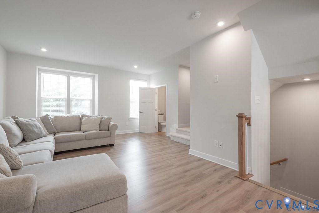 10221 Wenden Way, Hanover, VA 23005 Open-concept area featuring wood-finish flooring, recessed lighting, double-hung windows, and a wood-capped staircase railing