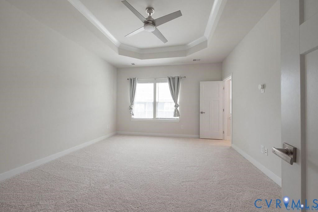 10221 Wenden Way, Hanover, VA 23005 Tray ceiling featuring a central brushed-metal ceiling fan, wall-to-wall carpeting, and a multi-panel door
