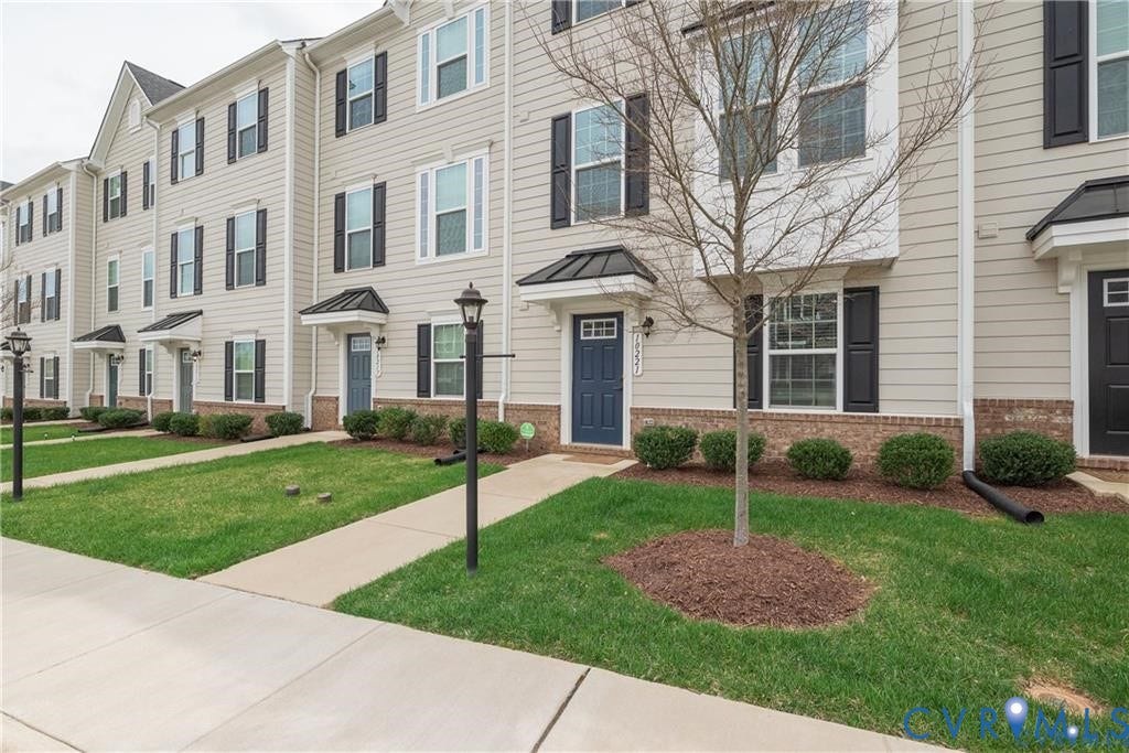 10221 Wenden Way, Hanover, VA 23005 Multi-story exterior featuring horizontal siding, brick veneer foundation, metal-accented door awnings, and black decorative shutters