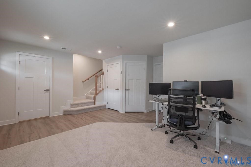 10221 Wenden Way, Hanover, VA 23005 Neutral-toned interior featuring wood-finish flooring, wall-to-wall carpeting, three-panel interior doors, recessed lighting, and a staircase with a wooden handrail