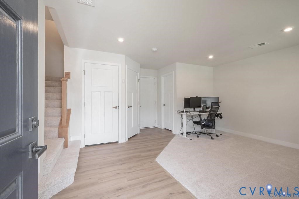 10221 Wenden Way, Hanover, VA 23005 Interior space featuring wood-finish flooring, recessed lighting, carpeted staircase with wood-capped railing, and multiple panel doors