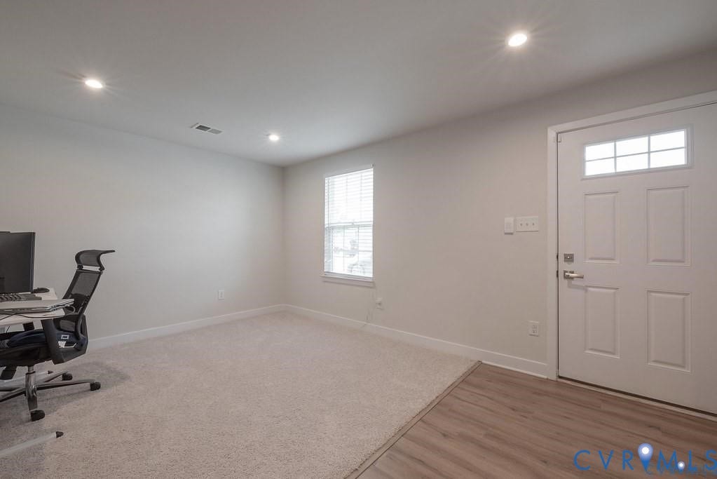 10221 Wenden Way, Hanover, VA 23005 Neutral interior room featuring recessed lighting, carpeted flooring, wood-finish entryway flooring, and a six-panel exterior door with a windowed transom