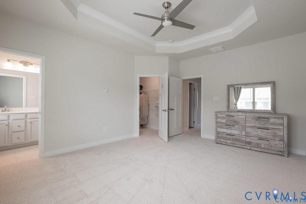 10221 Wenden Way, Hanover, VA 23005 Tray ceiling with recessed lighting and neutral wall-to-wall carpeting, featuring a mounted ceiling fan and interior doors with panel detailing
