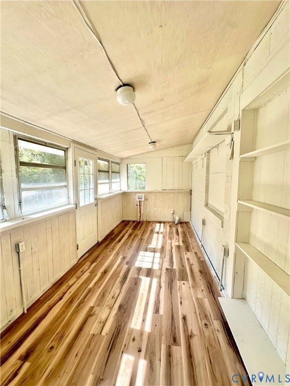 15051 BENT CREEK ROAD, Morven, Amelia, VA 23002 Enclosed porch featuring wood-finish flooring, painted vertical wood wall paneling, built-in shelving, and multiple windows
