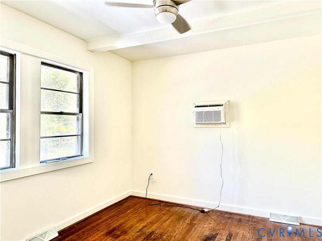 15051 BENT CREEK ROAD, Morven, Amelia, VA 23002 Interior room featuring wood-finish flooring, white walls, dual-pane windows, a ceiling fan with integrated lighting, and a wall-mounted air conditioning unit