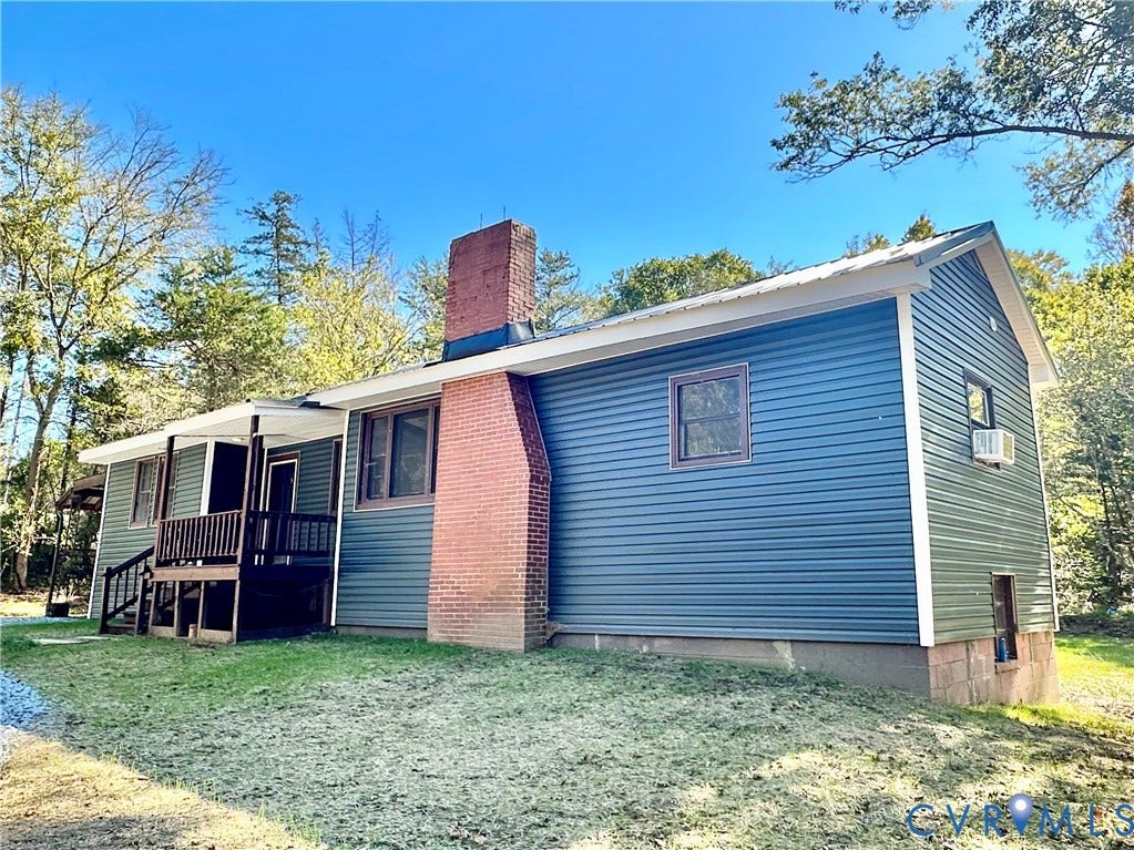 15051 BENT CREEK ROAD, Morven, Amelia, VA 23002 Blue vinyl siding exterior featuring an exposed brick chimney, metal roof, and an attached elevated wooden porch