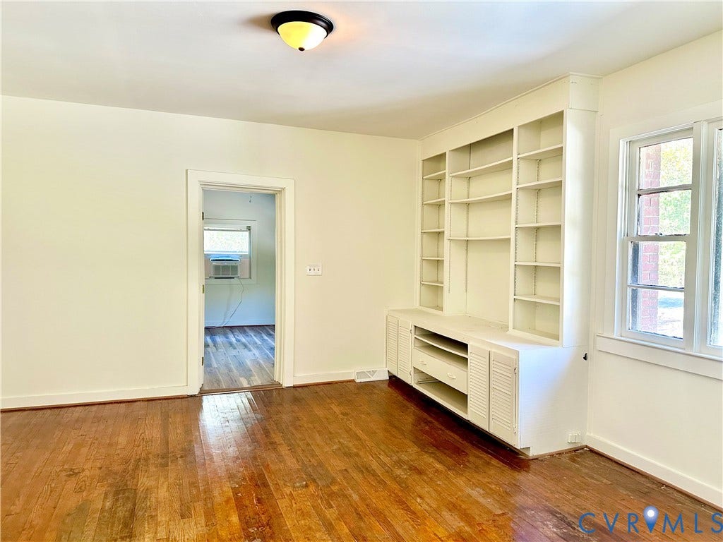 15051 BENT CREEK ROAD, Morven, Amelia, VA 23002 Room interior featuring hardwood flooring, built-in floor-to-ceiling shelving with cabinetry, and a flush-mount ceiling light fixture
