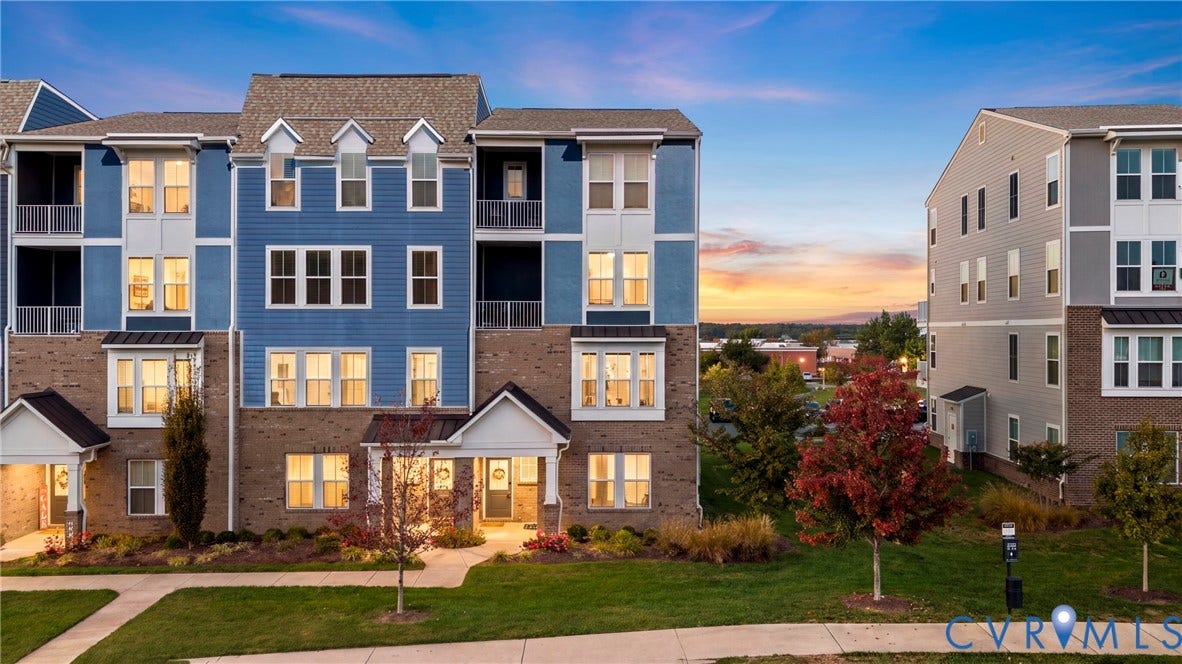 14501 Hancock Towns Drive, Chesterfield, VA 23832 Multi-story exterior featuring blue siding, brick masonry, gabled rooflines, recessed balconies, and manicured landscaping