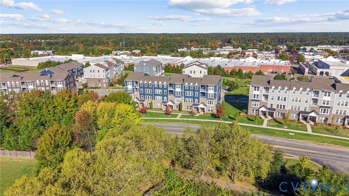 14501 Hancock Towns Drive, Chesterfield, VA 23832 Aerial perspective of multi-story residential buildings featuring blue and grey siding, masonry lower-level facades, gabled rooflines, and private balconies