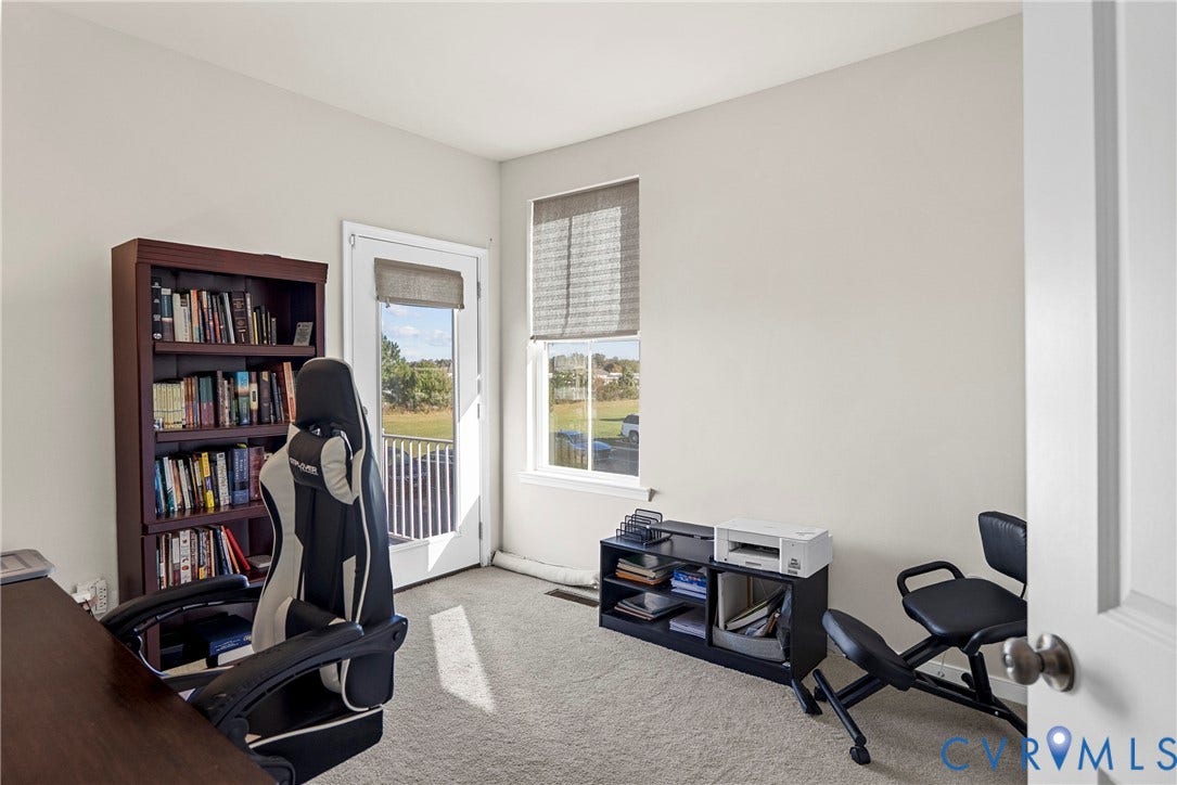 14501 Hancock Towns Drive, Chesterfield, VA 23832 Interior room featuring neutral-toned carpeting, a full-length glass-paneled door, and a single-hung window with a fabric roller shade