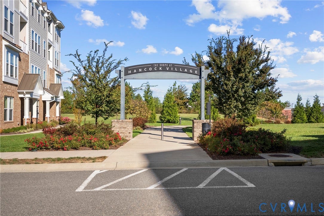 14501 Hancock Towns Drive, Chesterfield, VA 23832 Community entrance featuring masonry signage, concrete pathways, manicured landscaping, and mature trees