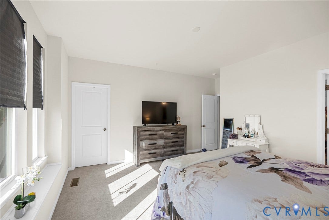 14501 Hancock Towns Drive, Chesterfield, VA 23832 Neutral-toned bedroom featuring carpeted flooring, two paneled doors, and large windows with integrated shades