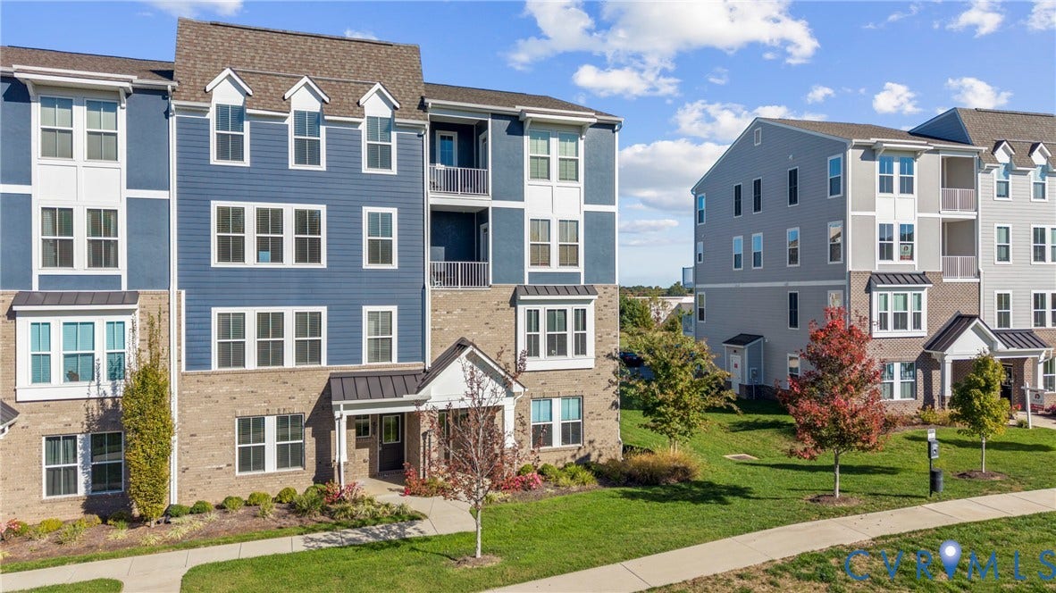 14501 Hancock Towns Drive, Chesterfield, VA 23832 Multi-story building exterior featuring a mix of horizontal lap siding and brick masonry, metal roof accents, recessed private balconies, and multi-pane windows