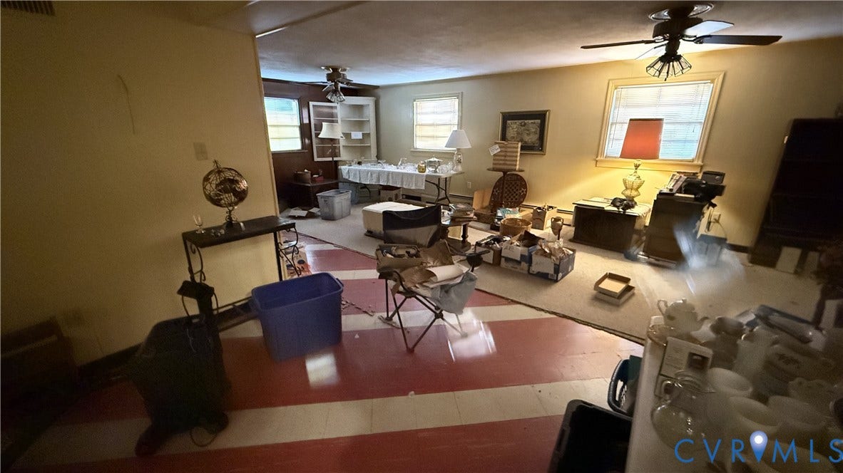 Interior space featuring two ceiling-mounted light fixtures with integrated fans, red and white striped flooring, wall-to-wall carpeting, and built-in shelving