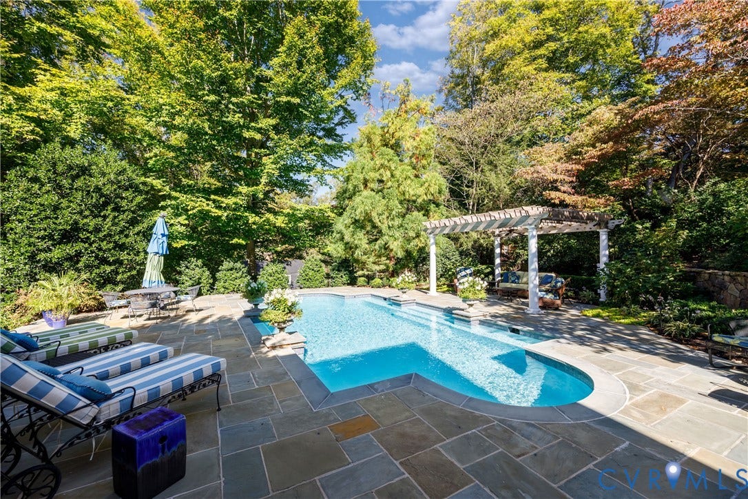 205 Poplar Lane, South Of Cary Street Rd, Richmond, VA 23226 In-ground saltwater, heated pool with flagstone decking and a custom pergola, surrounded by established trees and landscaping