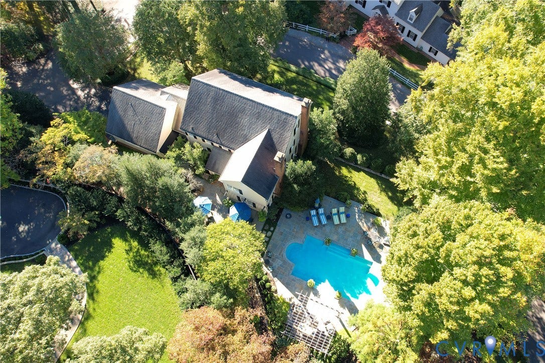 205 Poplar Lane, South Of Cary Street Rd, Richmond, VA 23226 Aerial perspective featuring a multi-story residence with a pitched roof, in-ground swimming pool, stone-surfaced patio, pergola, and landscaped grounds with mature trees